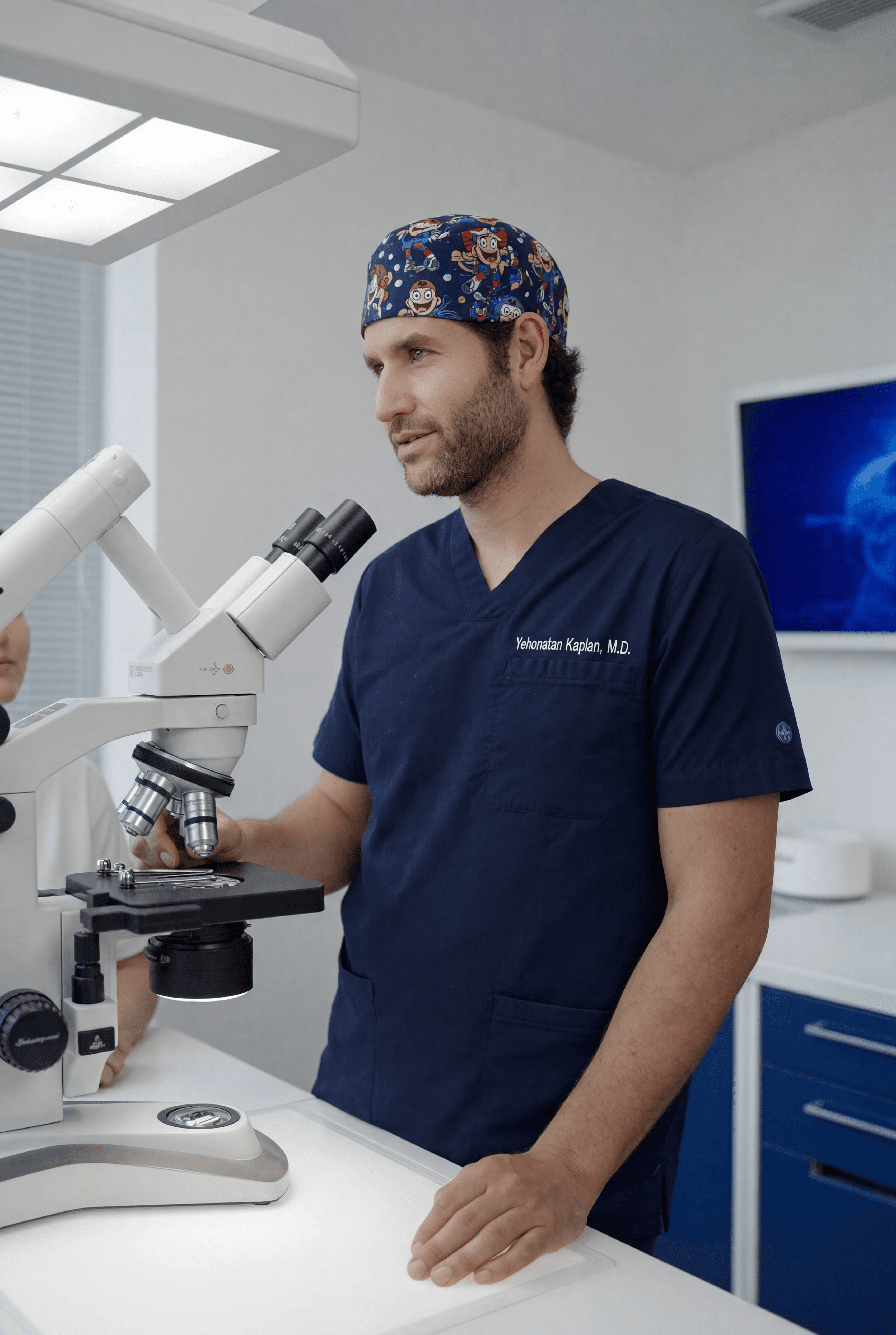 Dr. Kaplan with microscope in the lab